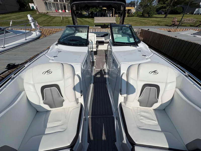 Slide: The Image of 2017 Monterey 328 Super Sport boat with luxurious white seating and sleek design. - 12