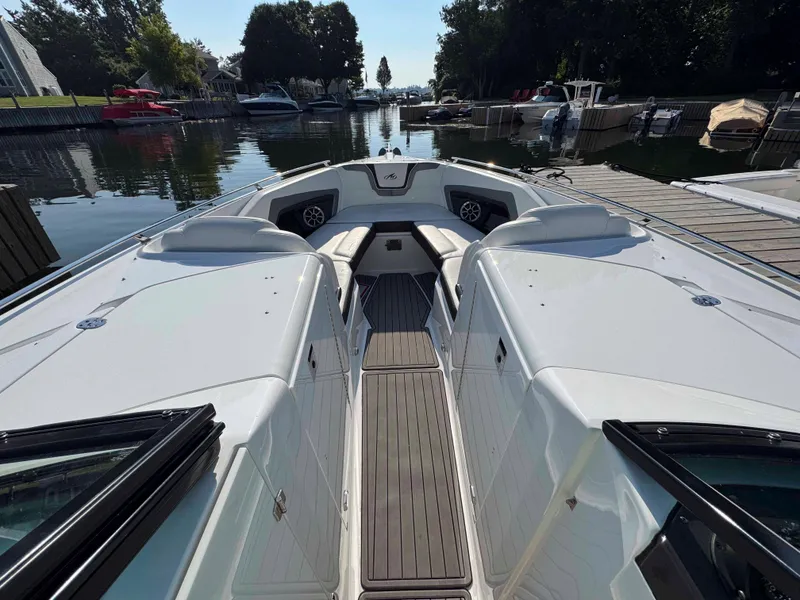 Slide: The Image of 2017 Monterey 328 Super Sport boat docked in a serene marina setting. - 15