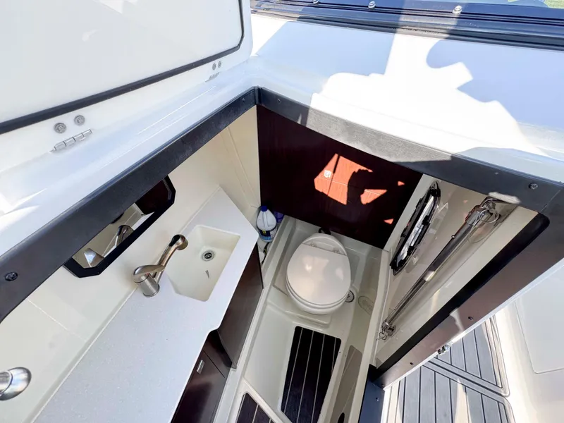 Slide: The Image of 2017 Monterey 328 Super Sport boat interior with compact bathroom and sink. - 17