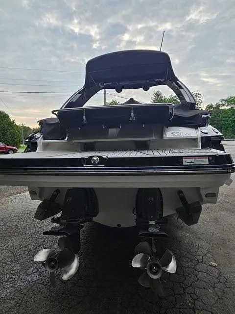 Slide: The Image of 2017 Monterey 328 Super Sport boat, rear view with dual propellers, parked outdoors. - 23