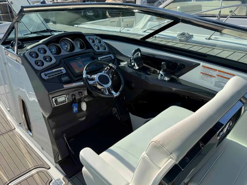 Slide: The Image of 2017 Monterey 328 Super Sport boat cockpit with modern controls and steering wheel. - 7