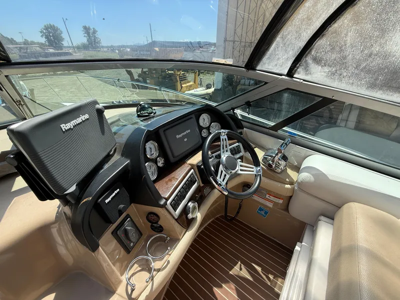 Slide: The Image of 2008 Four Winns V358 boat cockpit with Raymarine navigation system and modern steering wheel. - 12