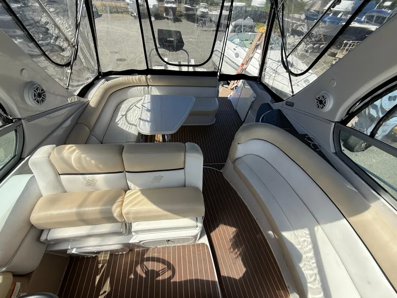 Slide: The Image of 2008 Four Winns V358 boat interior with beige seating and wooden flooring. - 13