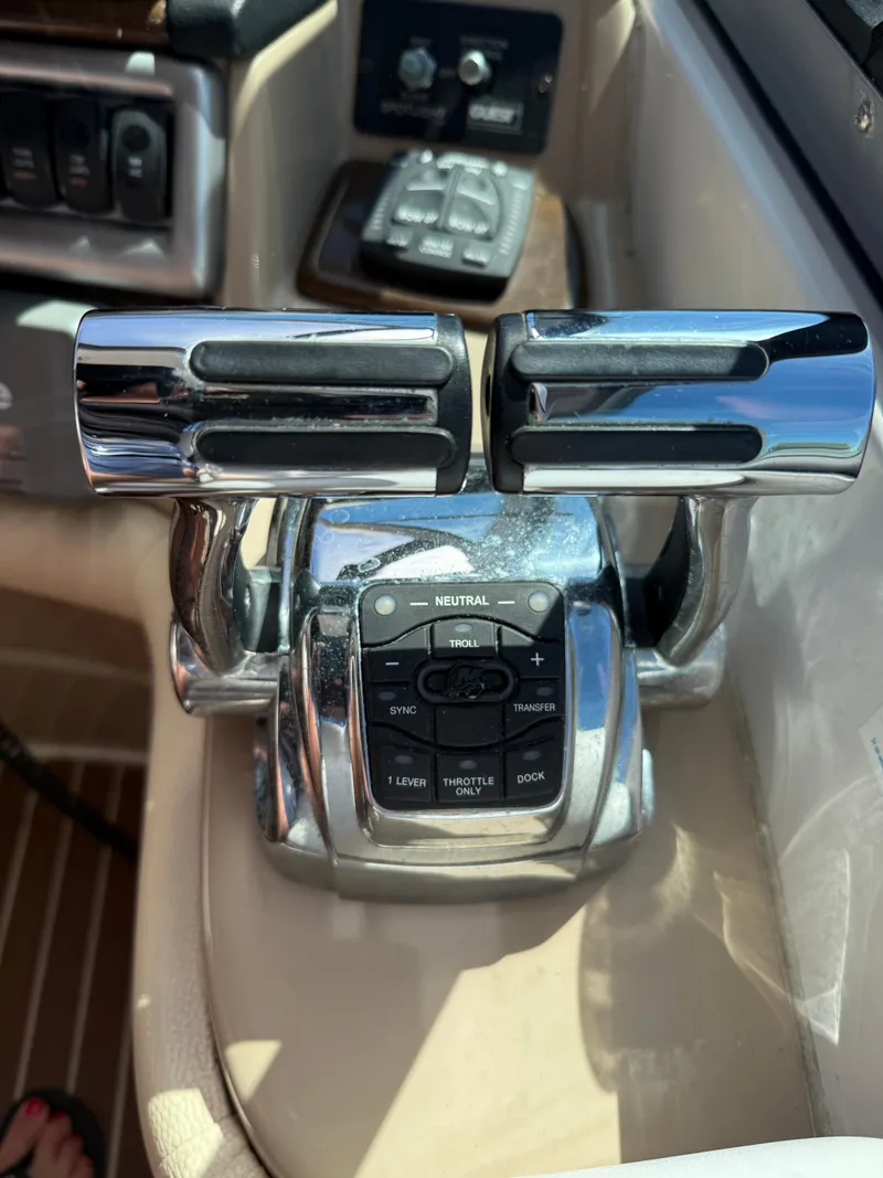 Slide: The Image of Throttle controls on a 2008 Four Winns V358 boat dashboard. - 17