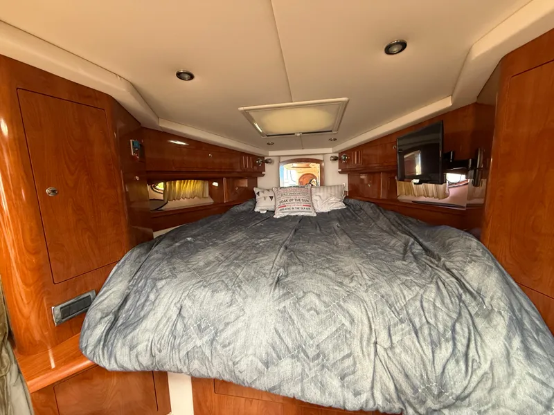 Slide: The Image of Interior cabin of 2008 Four Winns V358 boat with bed and wooden cabinetry. - 21