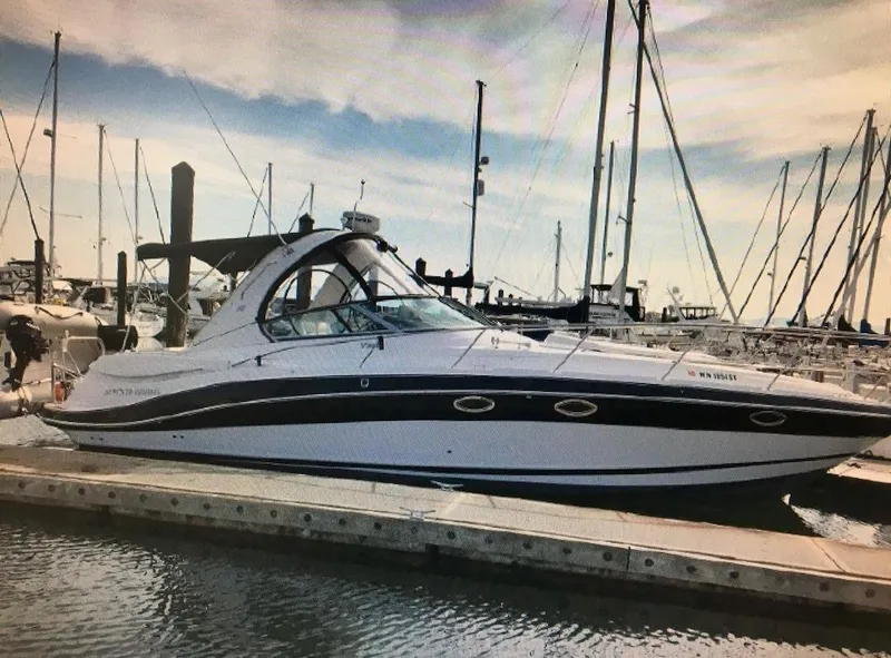 Slide: The Image of 2008 Four Winns V358 boat docked at marina with sailboats in background. - 4