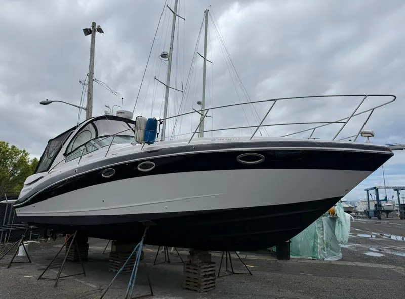 Slide: The Image of 2008 Four Winns V358 boat on stands, overcast sky, marina background. - 5