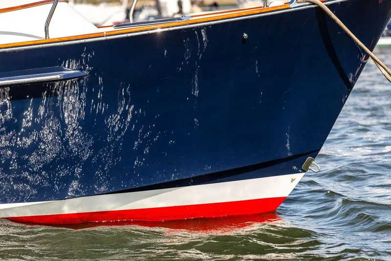 Slide: The Image of Close-up of 2014 Bruckmann Abaco 40 yacht bow in water, featuring sleek navy and red design. - 13
