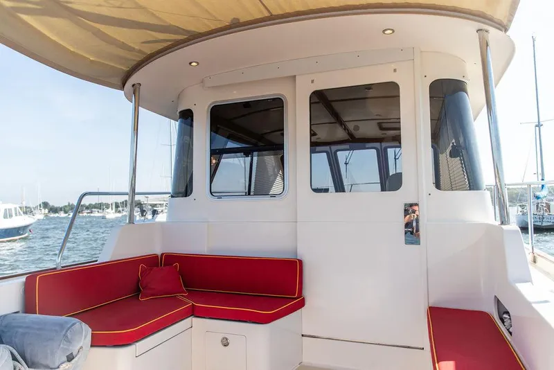 Slide: The Image of Bruckmann Abaco 40 yacht interior with red seating, 2014 model, docked at marina. - 18
