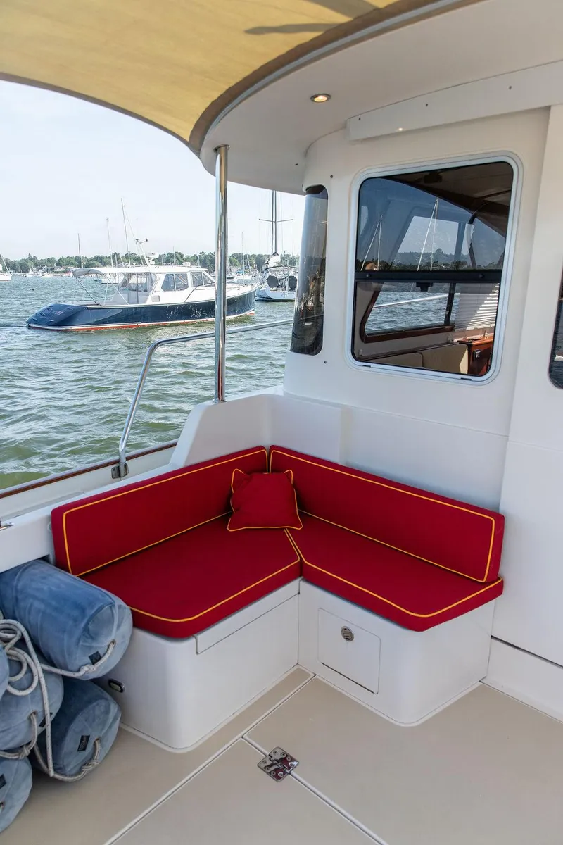 Slide: The Image of Red cushioned seating on 2014 Bruckmann Abaco 40 yacht deck, overlooking marina. - 22