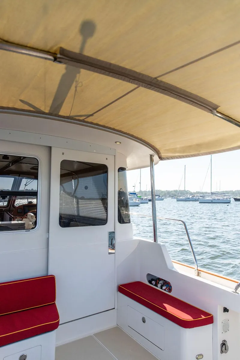 Slide: The Image of Bruckmann Abaco 40 yacht interior with red seating, docked in a marina, 2014 model. - 26