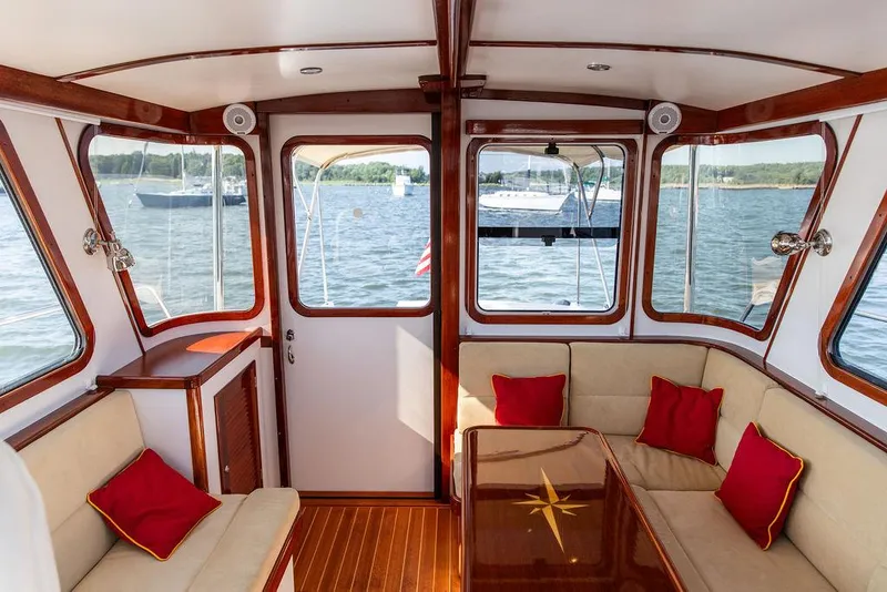 Slide: The Image of Luxurious interior of 2014 Bruckmann Abaco 40 yacht with red cushions and wooden accents. - 27