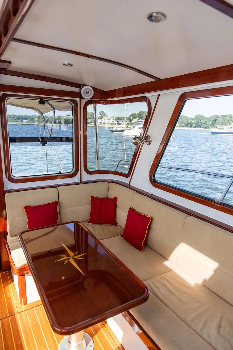 Slide: The Image of Interior of 2014 Bruckmann Abaco 40 yacht with beige seating and red cushions. - 28