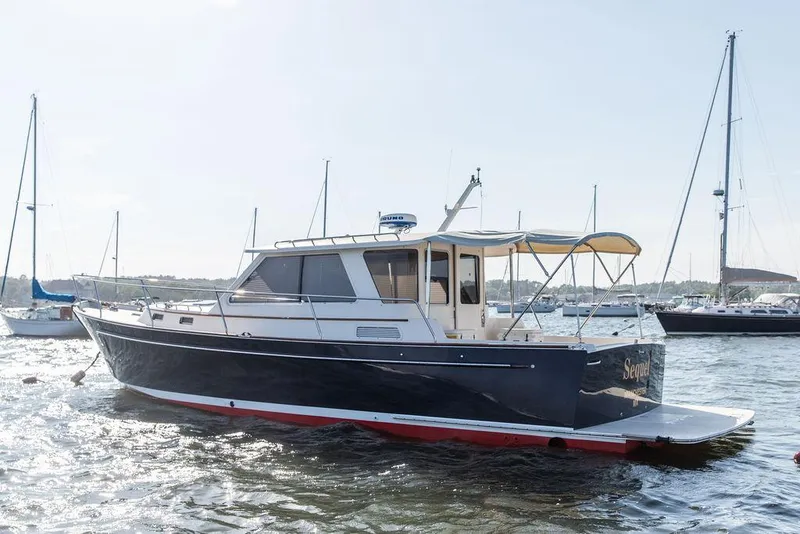 Slide: The Image of 2014 Bruckmann Abaco 40 yacht on water, featuring sleek design and canopy. - 4