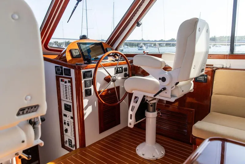 Slide: The Image of Helm of 2014 Bruckmann Abaco 40 yacht with captain's chair and wooden steering wheel. - 40