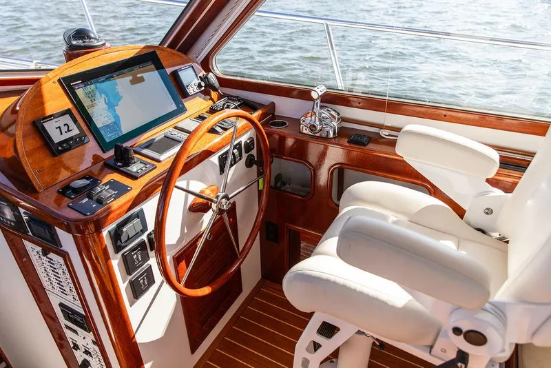 Slide: The Image of Luxurious helm of 2014 Bruckmann Abaco 40 yacht with wooden steering wheel and navigation equipment. - 41