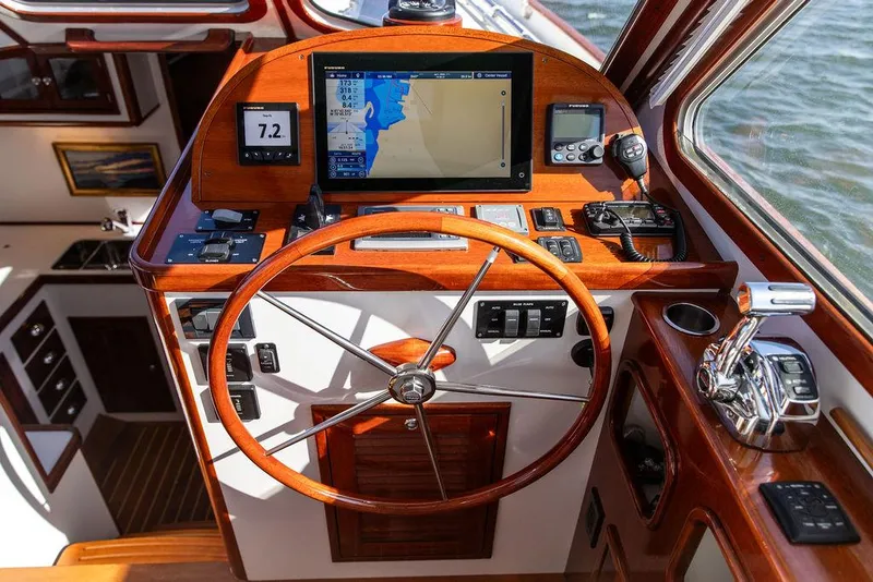 Slide: The Image of Helm of 2014 Bruckmann Abaco 40 yacht with navigation equipment and wooden steering wheel. - 42