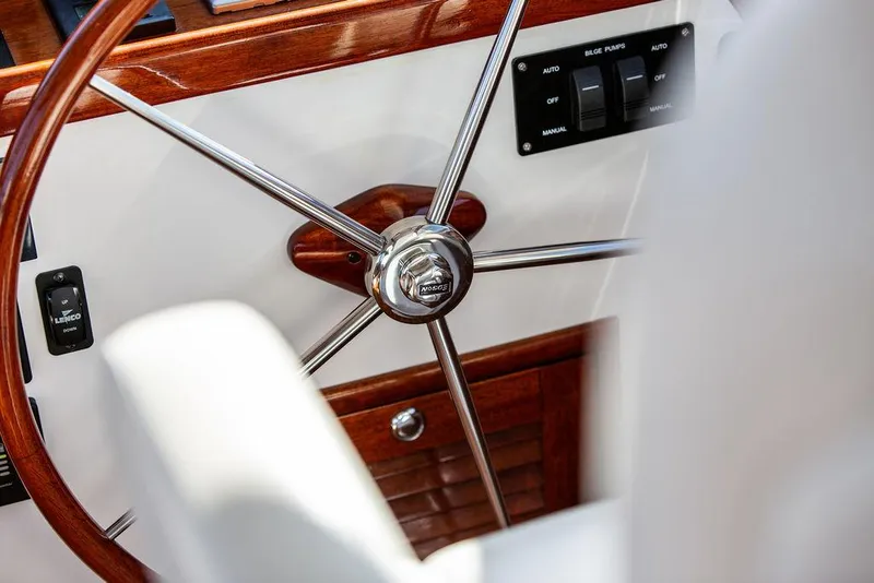 Slide: The Image of Steering wheel of 2014 Bruckmann Abaco 40 yacht, featuring polished wood and metal accents. - 46