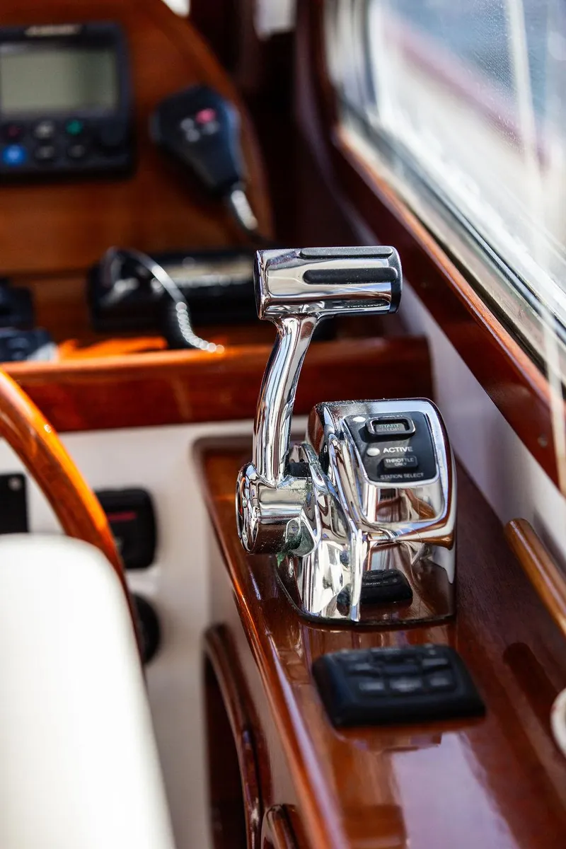 Slide: The Image of Close-up of Bruckmann Abaco 40 yacht controls, featuring polished chrome throttle and wooden dashboard, 2014 model. - 49