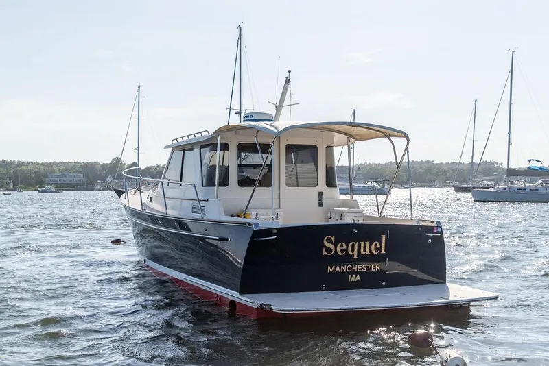 Slide: The Image of Bruckmann Abaco 40 yacht, 2014 model, named "Sequel," docked in a scenic harbor. - 6