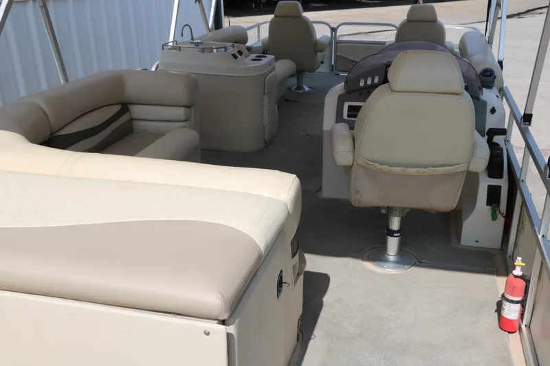 Slide: The Image of 2007 Bennington 2577 RFi pontoon boat interior with beige seating and helm. - 13