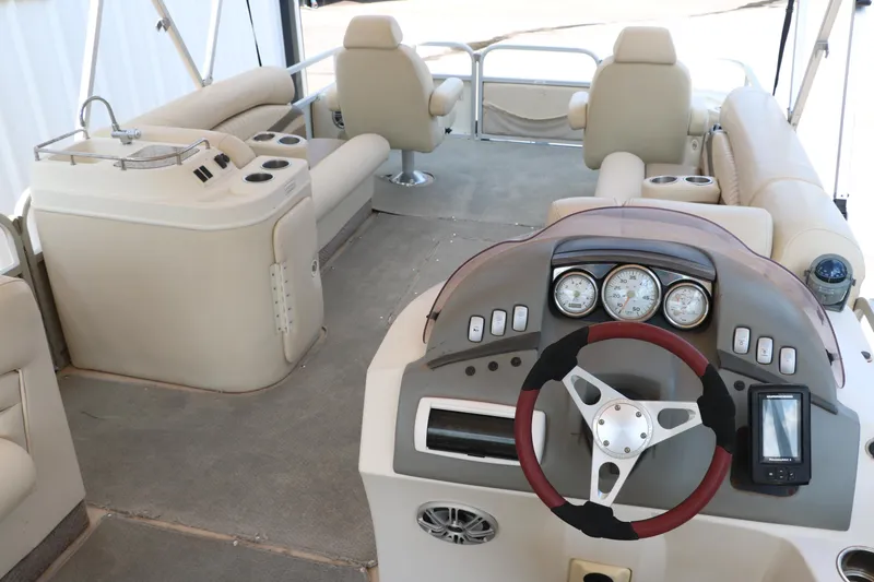 Slide: The Image of 2007 Bennington 2577 RFi boat interior with steering console and seating area. - 18