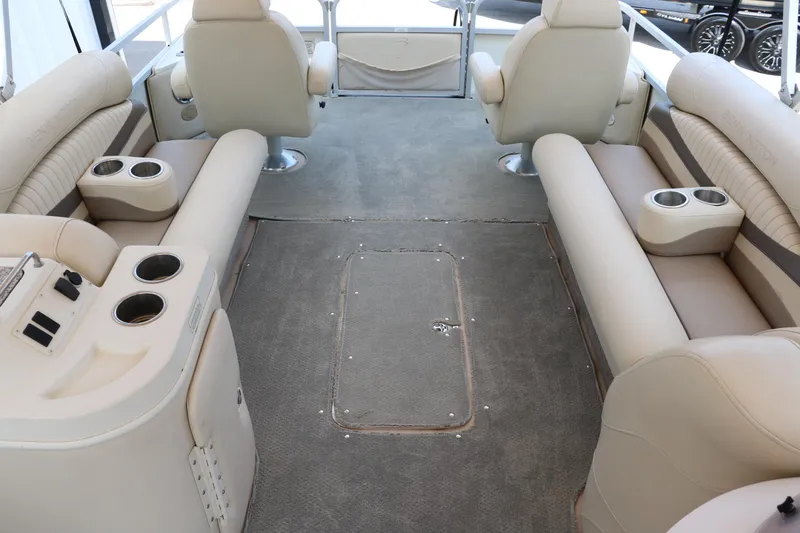 Slide: The Image of 2007 Bennington 2577 RFi boat interior with beige seating and cup holders. - 23