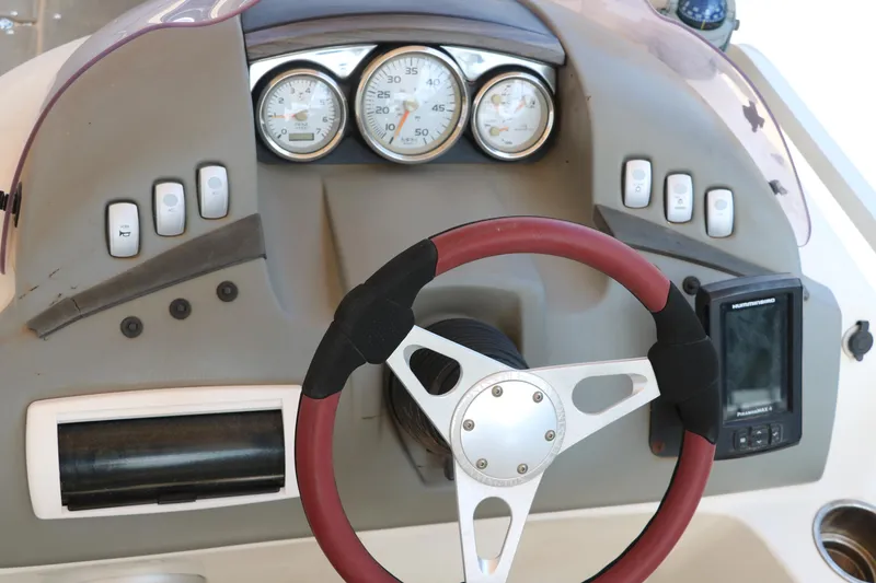 Slide: The Image of Dashboard of a 2007 Bennington 2577 RFi boat with steering wheel and gauges. - 25