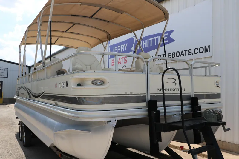 Slide: The Image of 2007 Bennington 2577 RFi pontoon boat with canopy, displayed at dealership. - 4