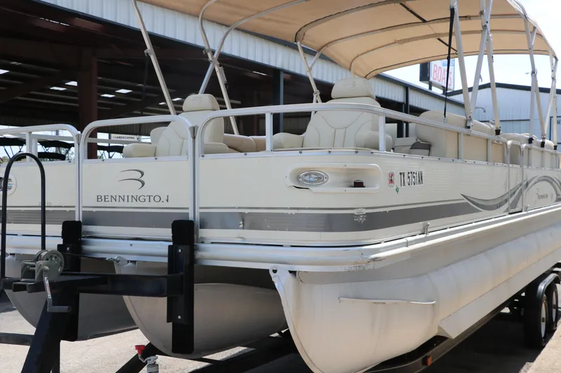 Slide: The Image of 2007 Bennington 2577 RFi pontoon boat with canopy, docked in a marina. - 5