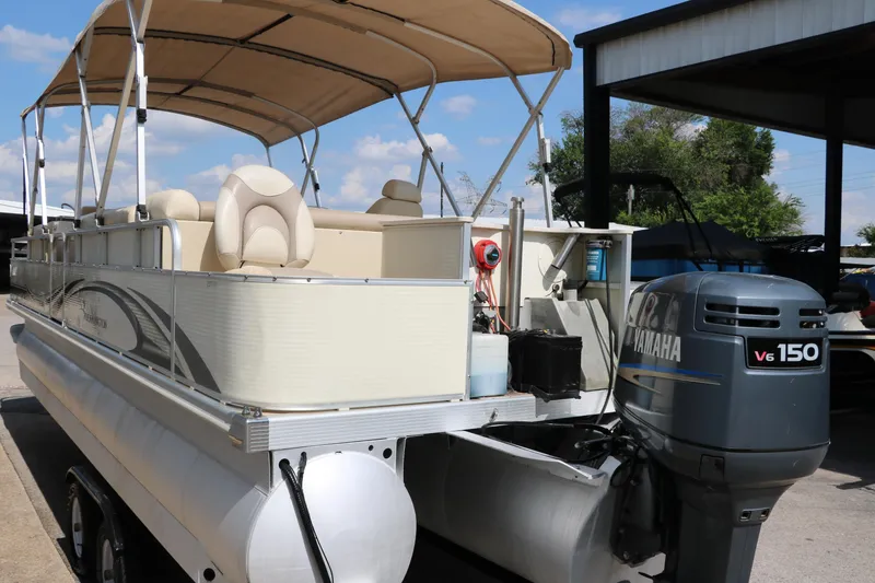 Slide: The Image of 2007 Bennington 2577 RFi pontoon boat with Yamaha V6 150 engine, docked under a canopy. - 6