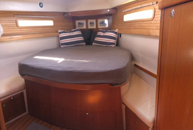 Slide: The Image of Cozy cabin interior of 2019 Catalina 425 sailboat with comfortable bed and striped pillows. - 11
