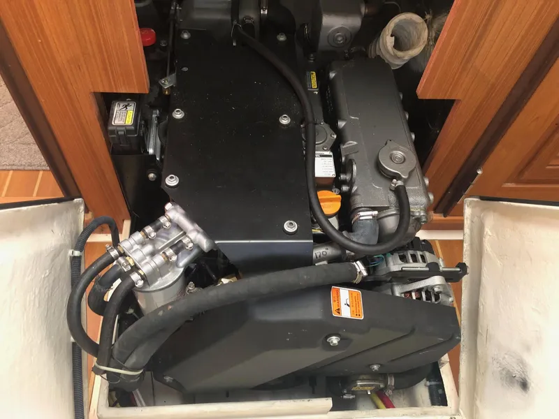 Slide: The Image of Engine compartment of a 2019 Catalina 425 sailboat, showcasing mechanical components and hoses. - 13