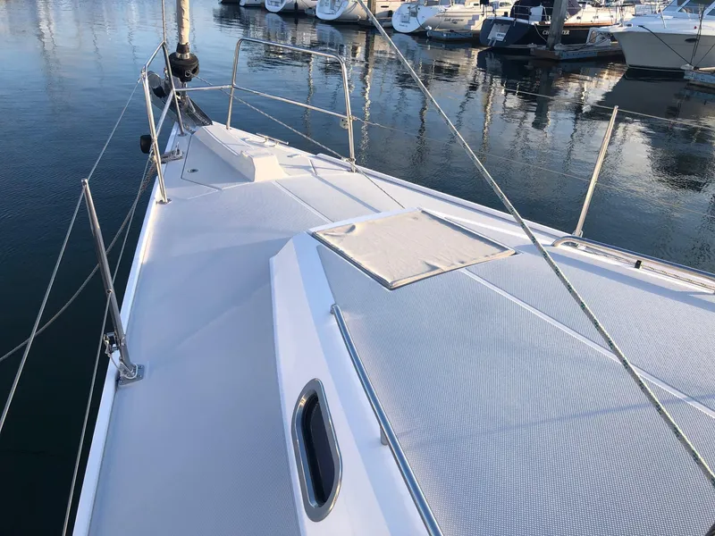 Slide: The Image of Sailboat deck of 2019 Catalina 425 in marina, showcasing sleek design and moored yachts. - 16
