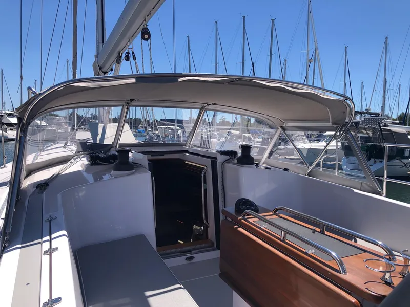 Slide: The Image of 2019 Catalina 425 sailboat cockpit with canopy, docked in a marina under clear blue skies. - 24