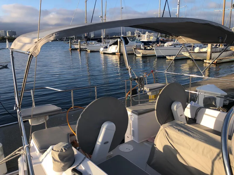Slide: The Image of 2019 Catalina 425 sailboat docked at marina, featuring covered cockpit and calm waters. - 31