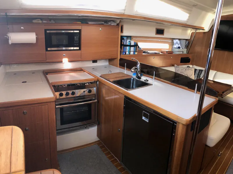 Slide: The Image of Modern kitchen interior of 2019 Catalina 425 yacht with wood cabinetry and appliances. - 5