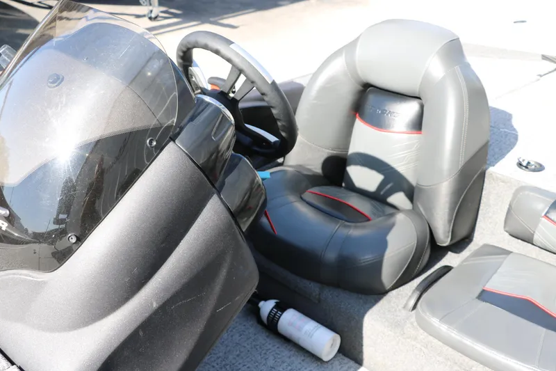 Slide: The Image of 2022 Tracker Pro Team 195 TXW Tournament Edition boat interior with steering wheel and seats. - 24