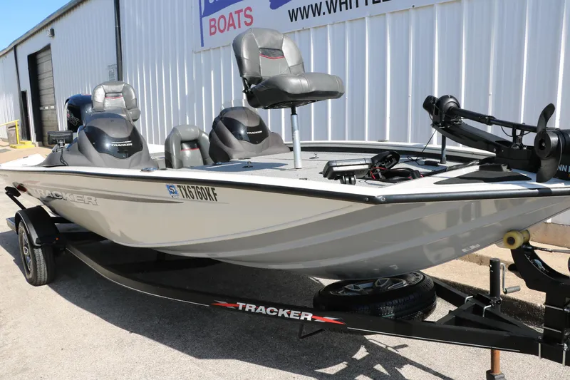 Slide: The Image of 2022 Tracker Pro Team 195 TXW Tournament Edition boat on trailer, parked outside a building. - 26