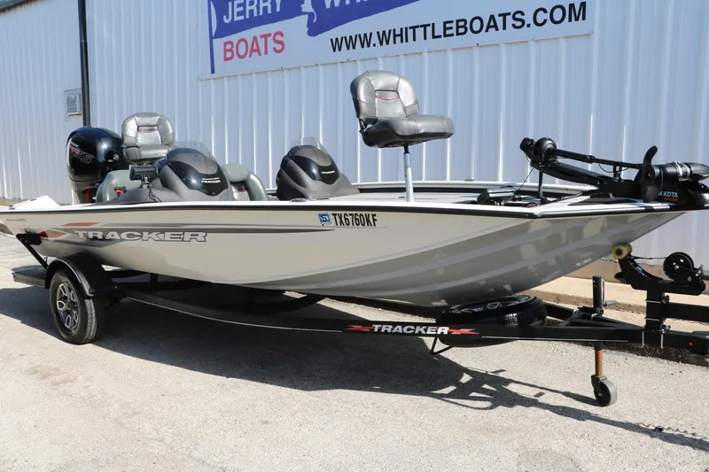 Slide: The Image of 2022 Tracker Pro Team 195 TXW Tournament Edition boat on trailer, parked outside dealership. - 4