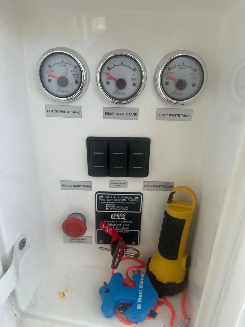 Slide: The Image of Control panel of 2016 Galeon 380 Fly with gauges and switches for water and waste tanks. - 12