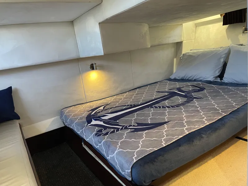 Slide: The Image of Cozy cabin interior of 2016 Galeon 380 Fly yacht with anchor-themed bedding. - 6