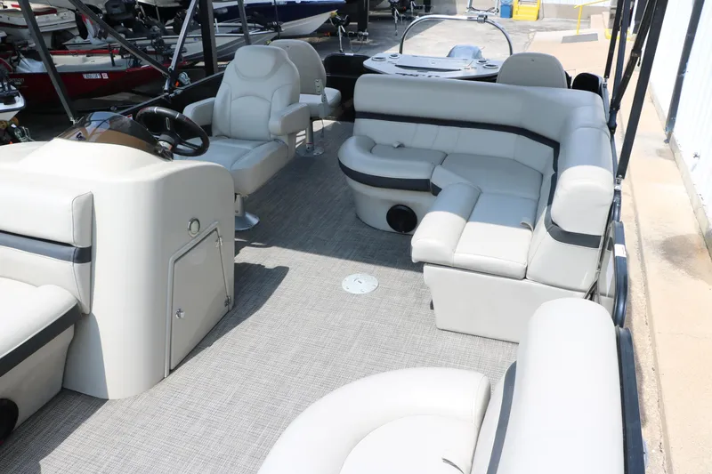 Slide: The Image of 2019 Berkshire 20RFC CTS pontoon boat interior with plush seating and steering console. - 15