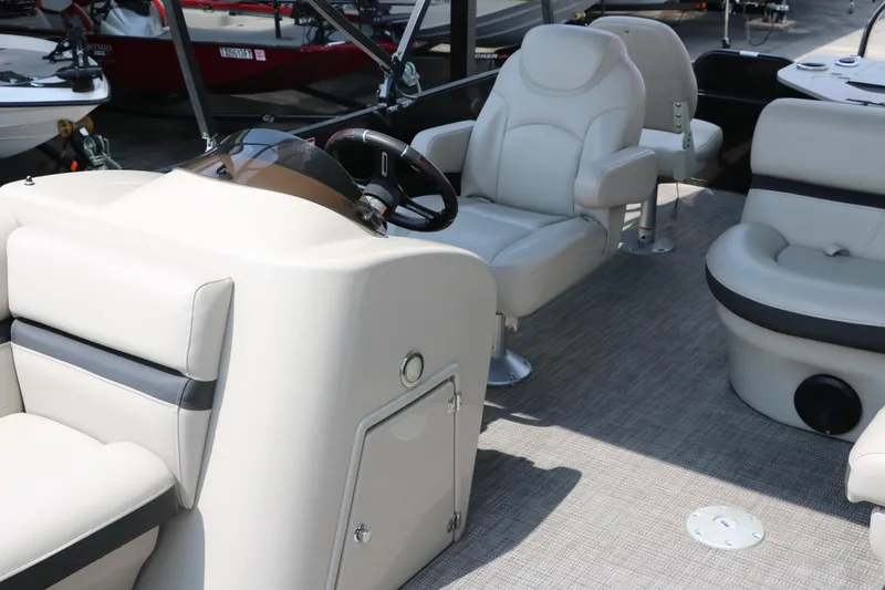 Slide: The Image of 2019 Berkshire 20RFC CTS pontoon boat interior with beige seating and steering console. - 17