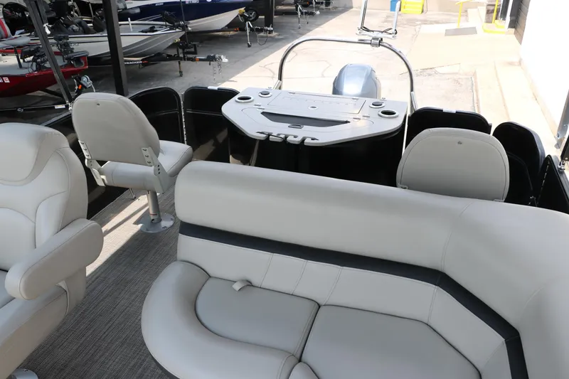 Slide: The Image of 2019 Berkshire 20RFC CTS pontoon boat interior with plush seating and helm. - 19
