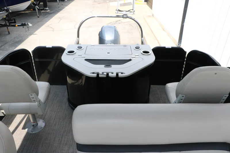 Slide: The Image of 2019 Berkshire 20RFC CTS pontoon boat interior with seating and control console. - 20