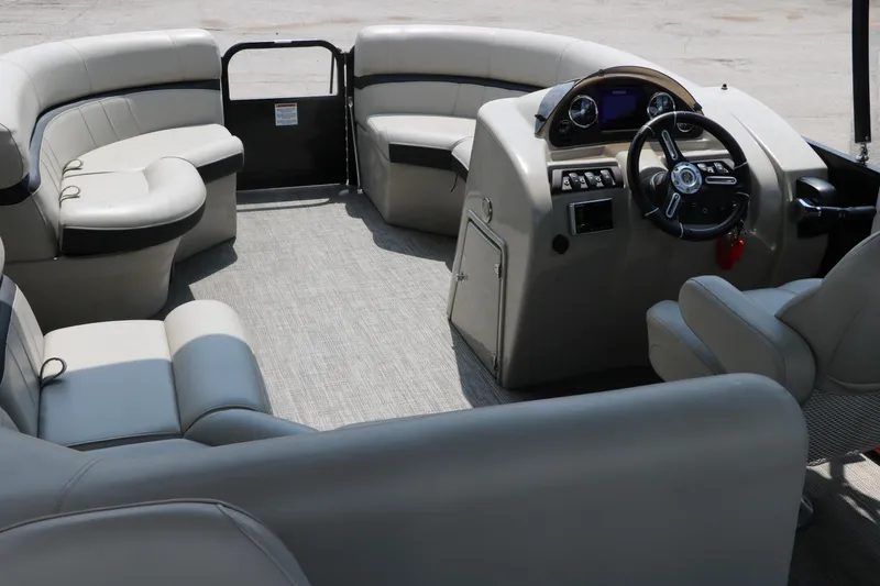 Slide: The Image of Interior of a 2019 Berkshire 20RFC CTS pontoon boat with plush seating and steering console. - 24