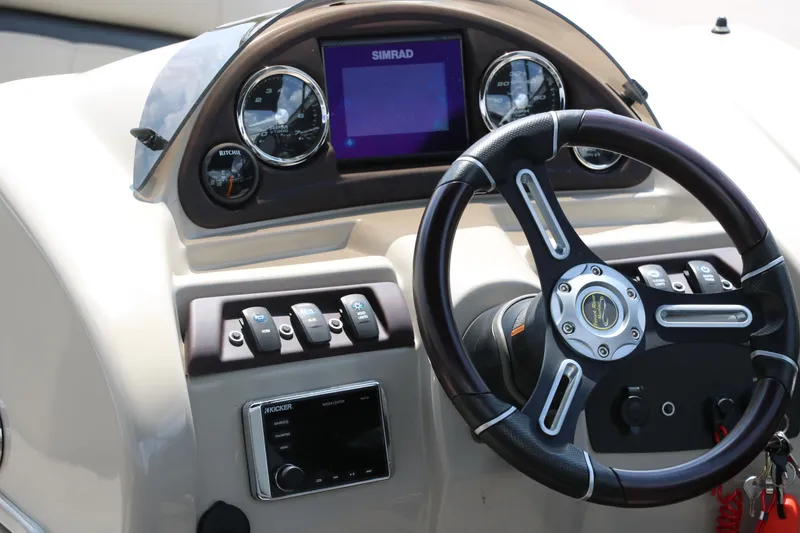 Slide: The Image of 2019 Berkshire 20RFC CTS boat dashboard with steering wheel and control panel. - 26