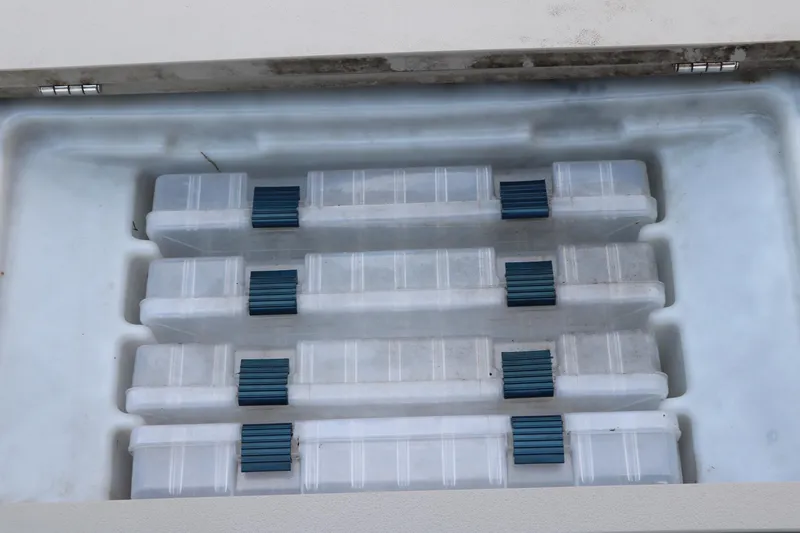 Slide: The Image of Storage compartment with organized plastic containers in a 2019 Berkshire 20RFC CTS boat. - 27