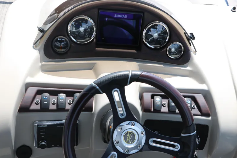 Slide: The Image of Steering console of 2019 Berkshire 20RFC CTS boat with gauges and controls. - 31